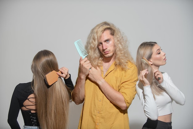 Hair Care Group Hairbrushing Hair With Brush Portrait Woman and Man Brushing Long Healthy Hair With Hairbrush Womens and Mans Haircut