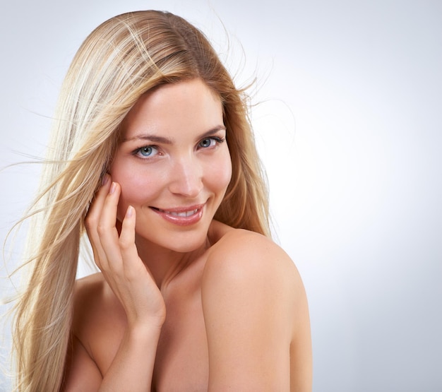 Hair care hand and beauty portrait of happy woman makeup or isolated on white studio background Face touch or hairstyle of blonde model in cosmetics skin and salon treatment on mockup with wind