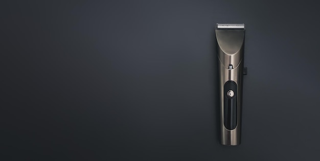 Photo hair clipper on black background hairdresser salon equipment concept