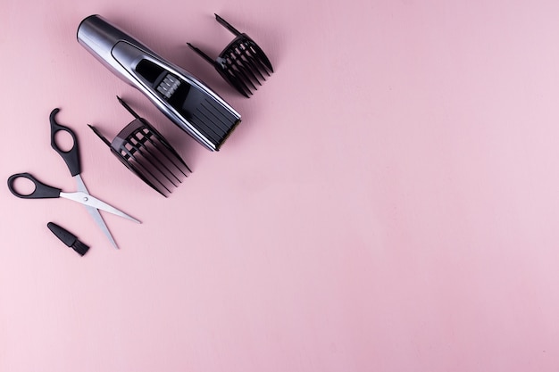 Photo hair clipper pink background.