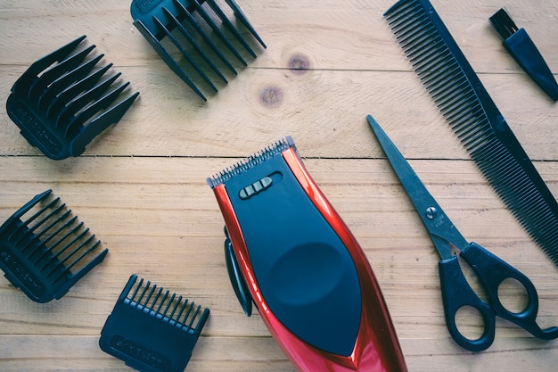 Hair clipper set on wood background