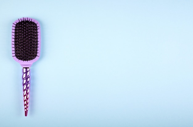 Hair comb on color background.