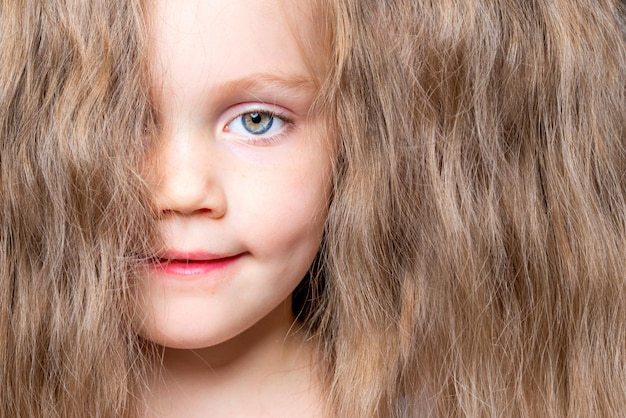 Hair covers face Little girl with beautiful blond hair