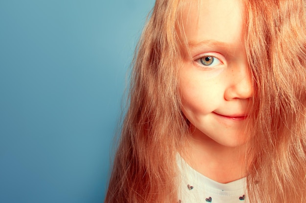 Hair covers face Little girl with beautiful blond hair