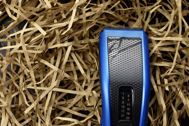 Hair cutter on a light straw background