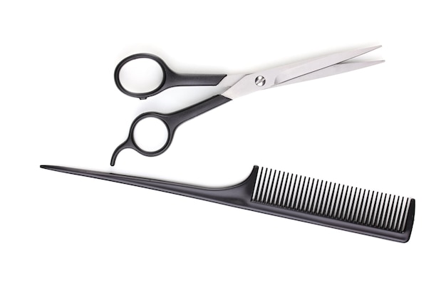 Hair cutting shears and comb isolated on white