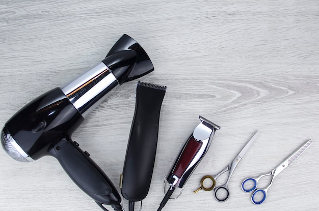 Hair cutting tools lie on a wooden background. Hair clipper. Hair clipper.