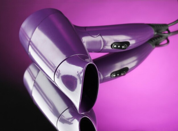 Hair dryer on purple background