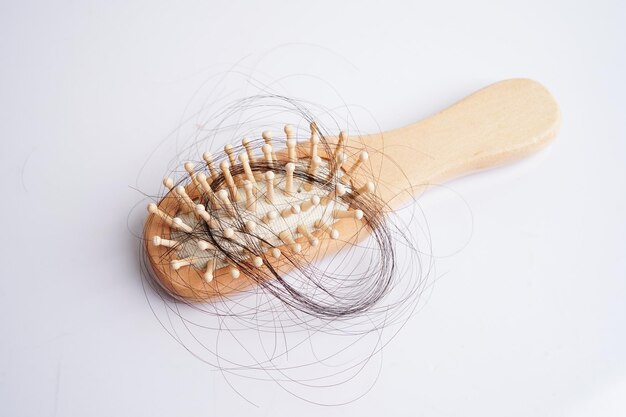 Hair loss fall with comb brush isolated on white background