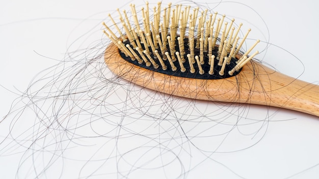 Hair loss stick to combHair loss serious problems and hair loss on a white background