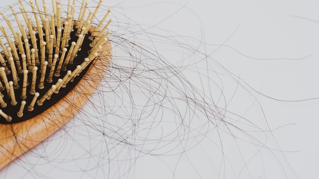 Hair loss stick to combHair loss serious problems and hair loss on a white background