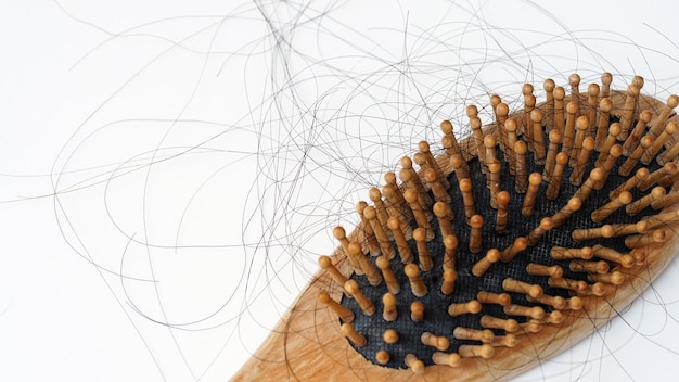 Hair loss stick to combHair loss serious problems and hair loss on a white background