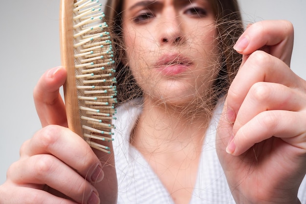 Photo hair loss in women young woman is upset because of hair loss portrait of frustrated girl with proble