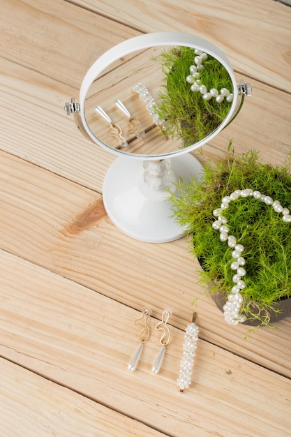 Hair pearl clip necklace earrings hairpins with pearls decoration mirror and reflection on grass