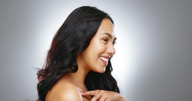 Hair profile and beauty woman with cosmetic care and salon treatment for growth on grey background Wind wellness and haircare texture and growth with shine cosmetology and skin in studio