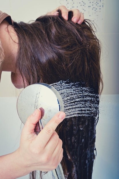 Premium Photo | Hair wash of woman in shower