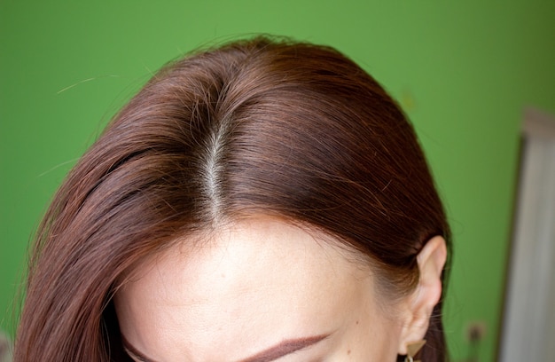 Hair on a woman's head close-up. Hair brown color of.