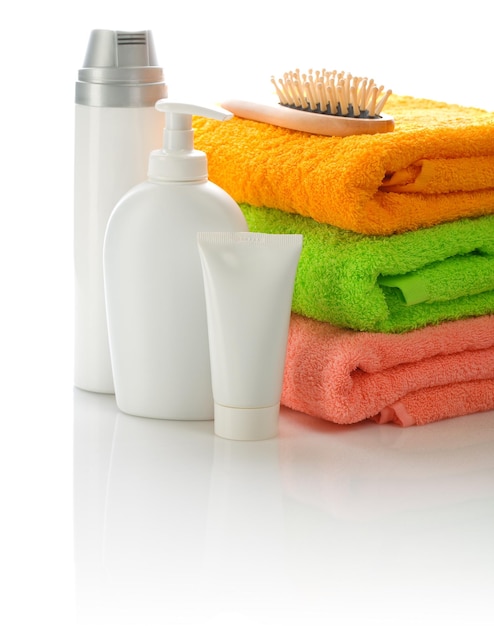 Hairbrush and bottles with towel