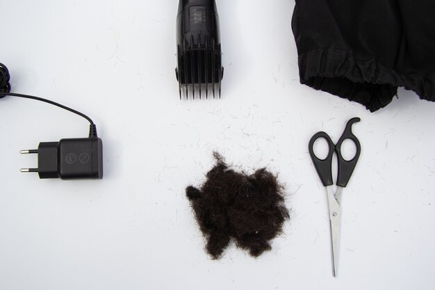 Haircut accessories comb typewriter cape black hair View from above