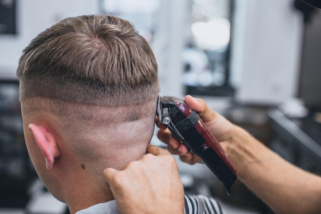 Haircut men Barbershop. Men's Hairdressers barbers. Barber cuts the client machine for haircuts.