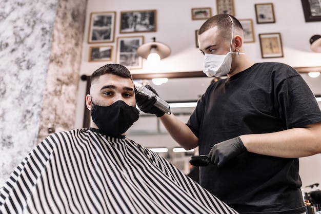 Haircut in quarantine. Haircut in masks from the virus. Hair and health care. Man haircut in