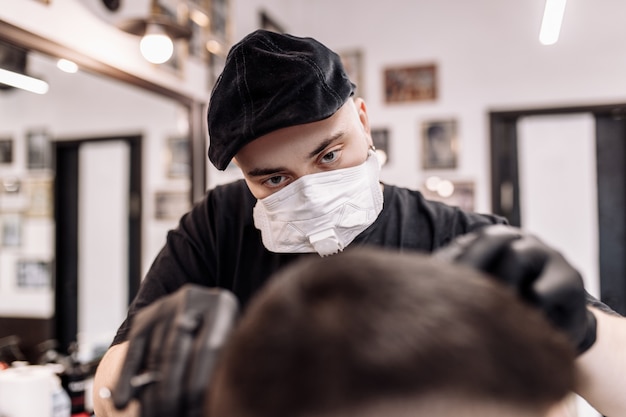 Haircut in quarantine. haircut in masks from the virus. hair and health care. man haircut in