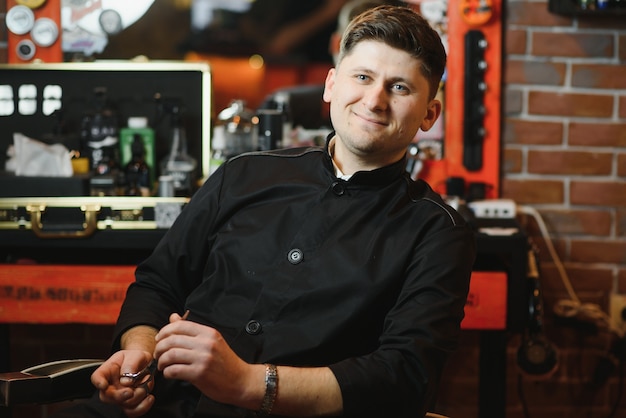 Hairdresser in barbershop chair with tools