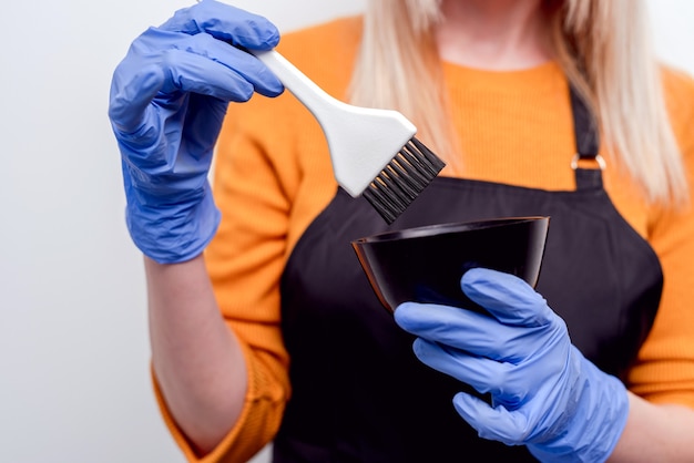 Hairdresser in beauty salon preparing for hair dye