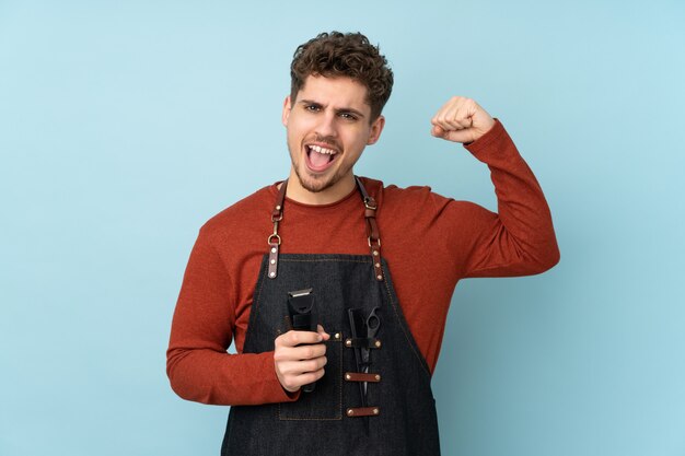 Hairdresser caucasian man on blue wall making strong gesture