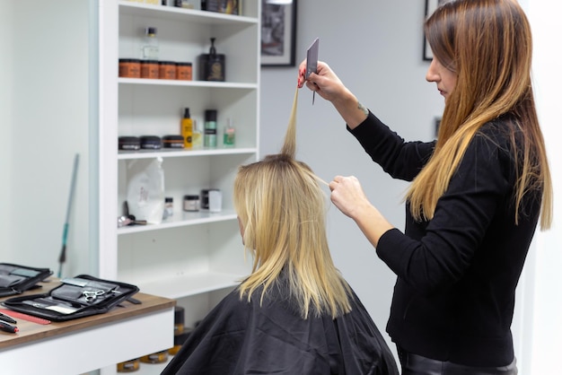 hairdresser cuts to
woman in the salon. close-up.concept of beauty and beauty sphere