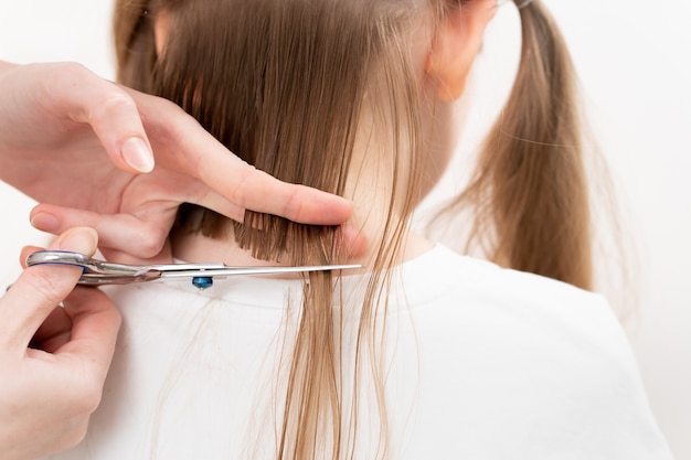 hairdresser Cutting hair to little girl