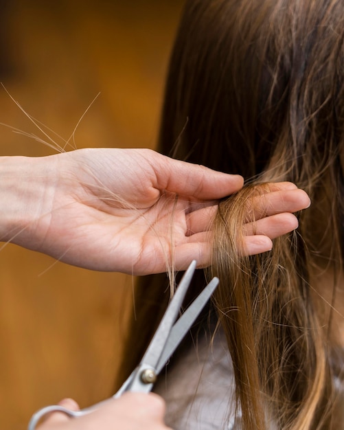 Photo hairdresser cutting little girl's hair