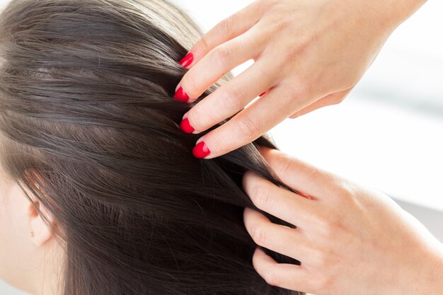 Hairdresser does hair style of woman