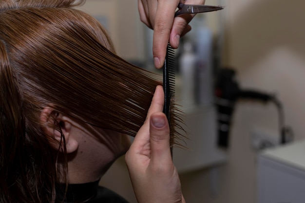 Парикмахер делает стрижку Профессиональные парикмахерские ножницы на рабочем месте