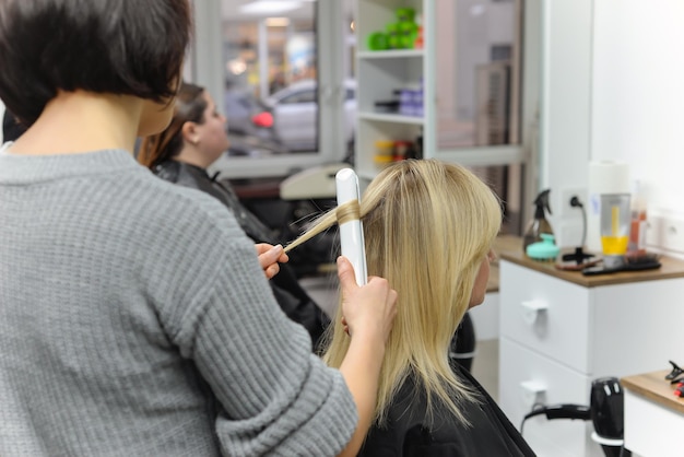 hairdresser dries hair with a hairdryer
woman in the salon. close-up.beauty and fashion concept