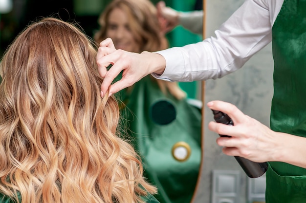 Hairdresser fixing hairstyle.