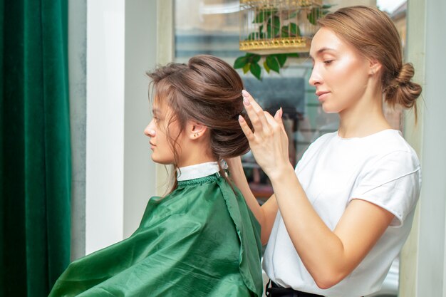 Hairdresser makes hairstyle