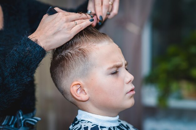 Premium Photo | Hairdresser makes a stylish hairstyle the woman is ...