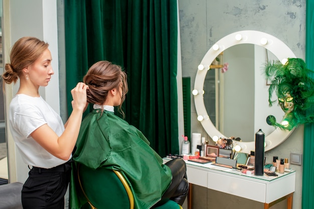 Hairdresser making hairstyle.