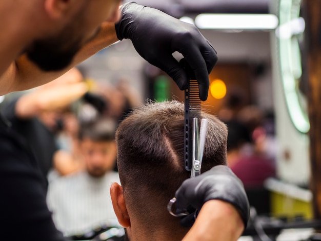 Hairdresser man giving a haircut