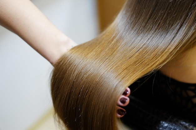 hairdresser salon hair colouring in process beautiful young female dyeing hairs showing the result closeup