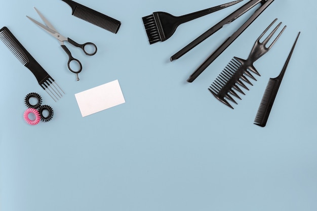 hairdresser set with various accessories on gray background. top view. copy space. still life. mock-up. flat lay