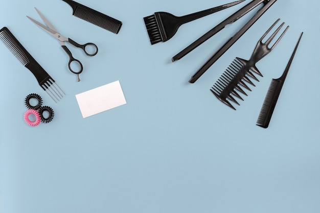 Hairdresser set with various accessories on gray background. Top view. Copy space. Still life. Mock-up. Flat lay