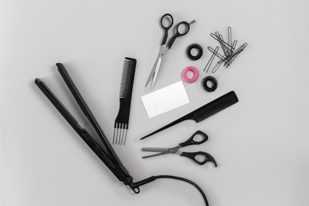 Hairdresser set with various accessories on gray background