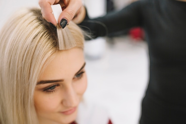 Photo hairdresser showing sample of hair color