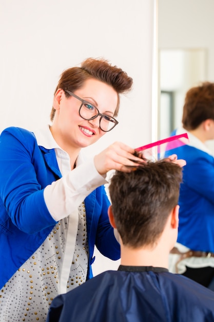 Hairdresser trimming man hair in barbershop