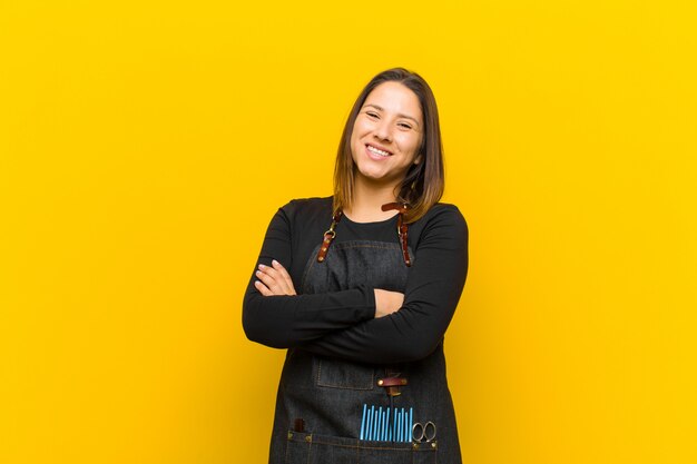 Hairdresser woman laughing happily with arms crossed with a relaxed positive and satisfied pose