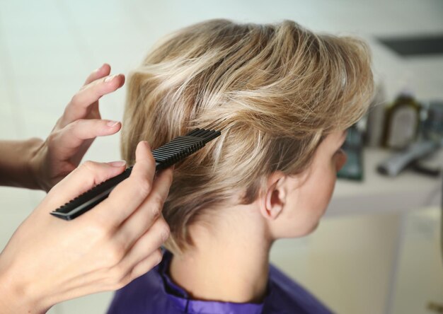 Hairdresser working with client at salon