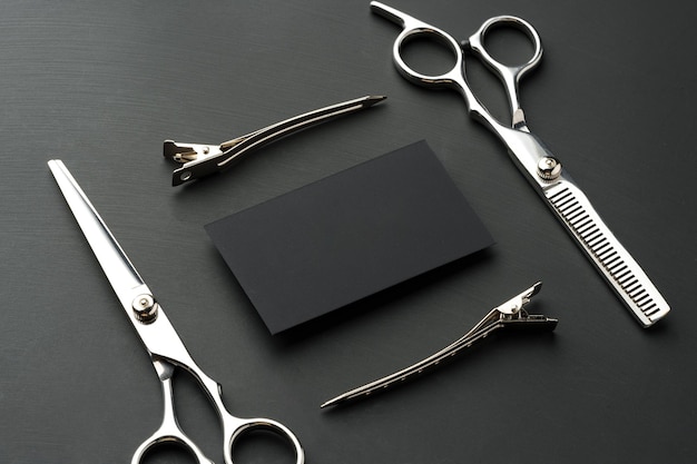 Hairdressing scissors and businesscard mock up on black background