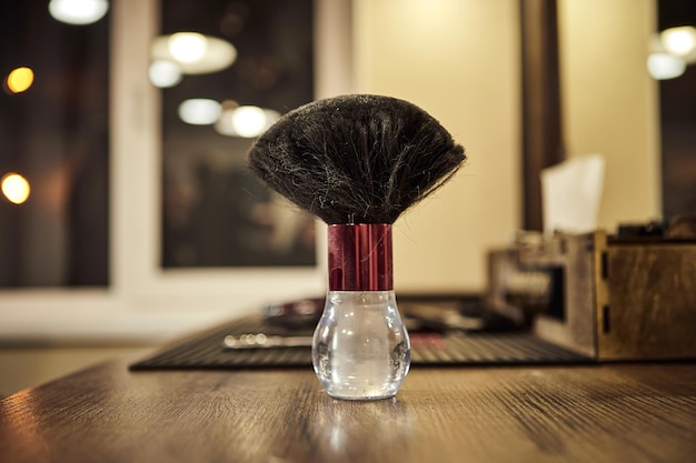 Hairdressing tools Barber brush for talcum powder stand on the table in the barbershop